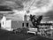 A classic black and white shot of a church, Greek flag, and cafe in Paros, Greece — GREEK